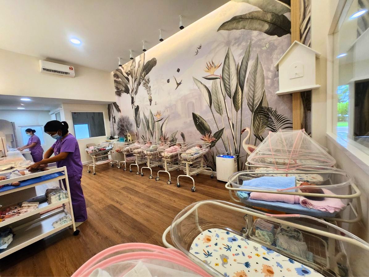 A NewBond infant nurse settling a sleeping newborn in the centre's nursery